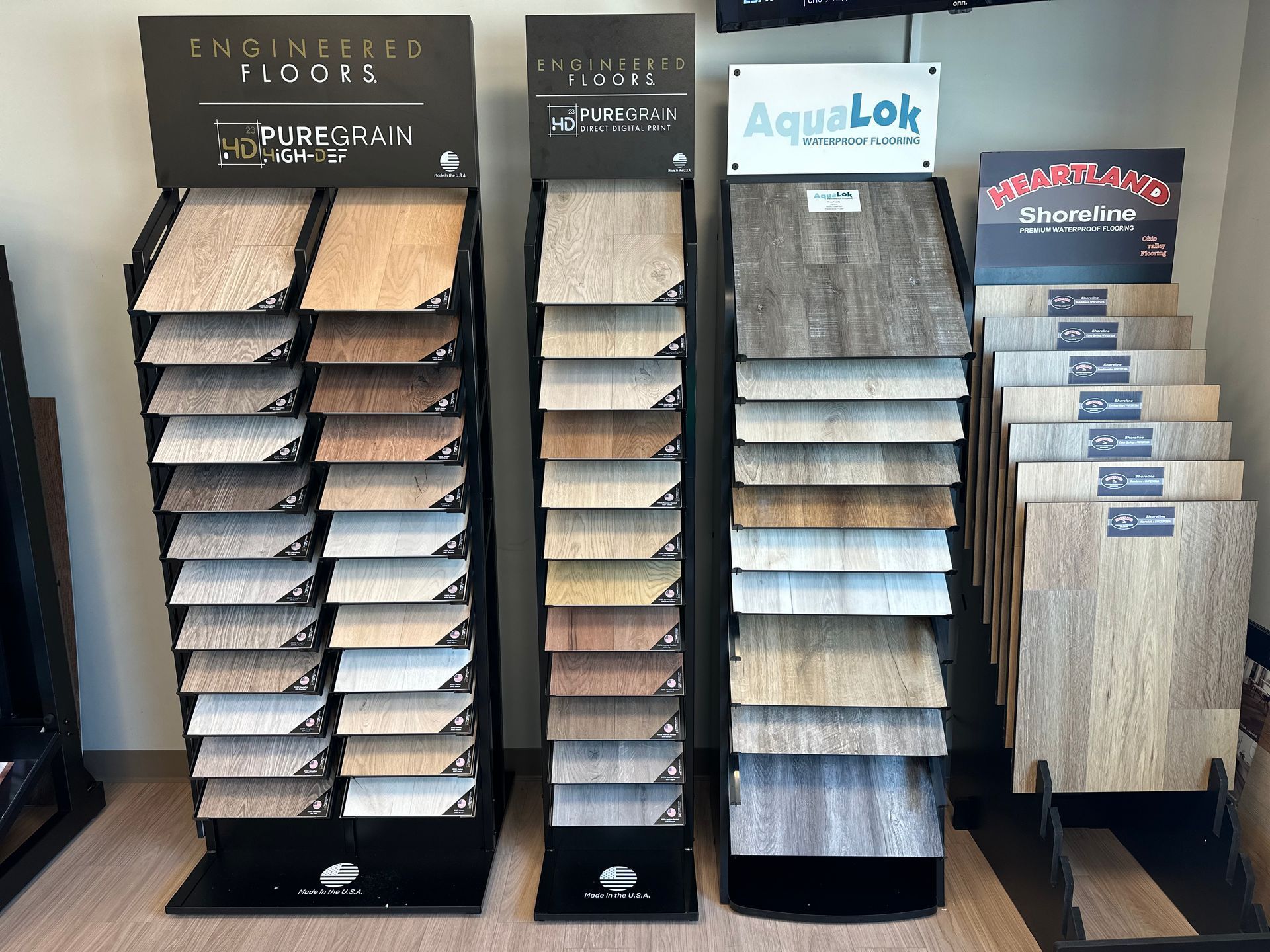 Display racks holding plank flooring samples in different colors and finishes